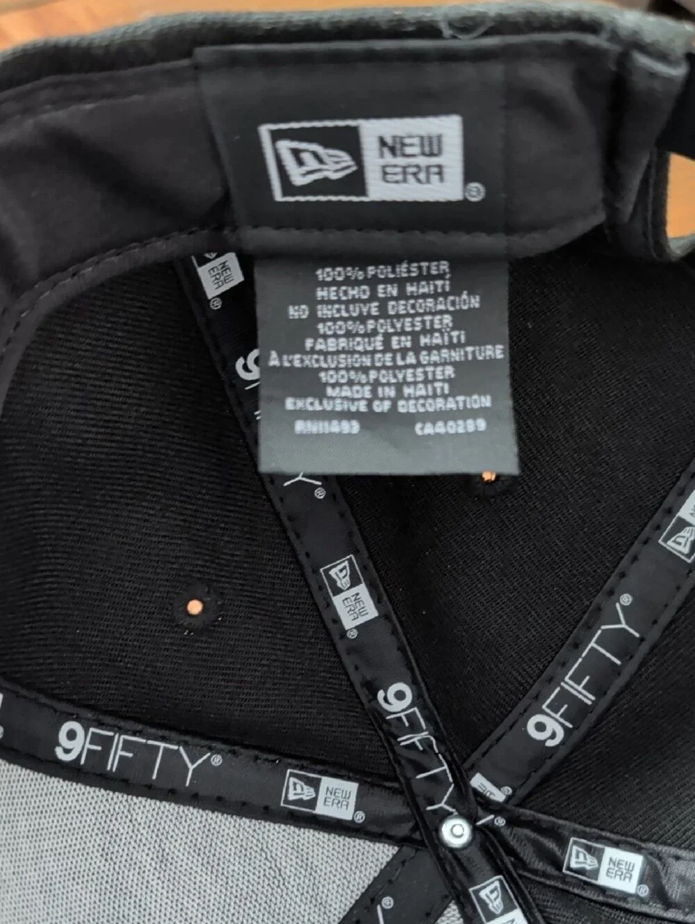 New Era Black Snapback Hat with Gray-Outlined Lion Patch